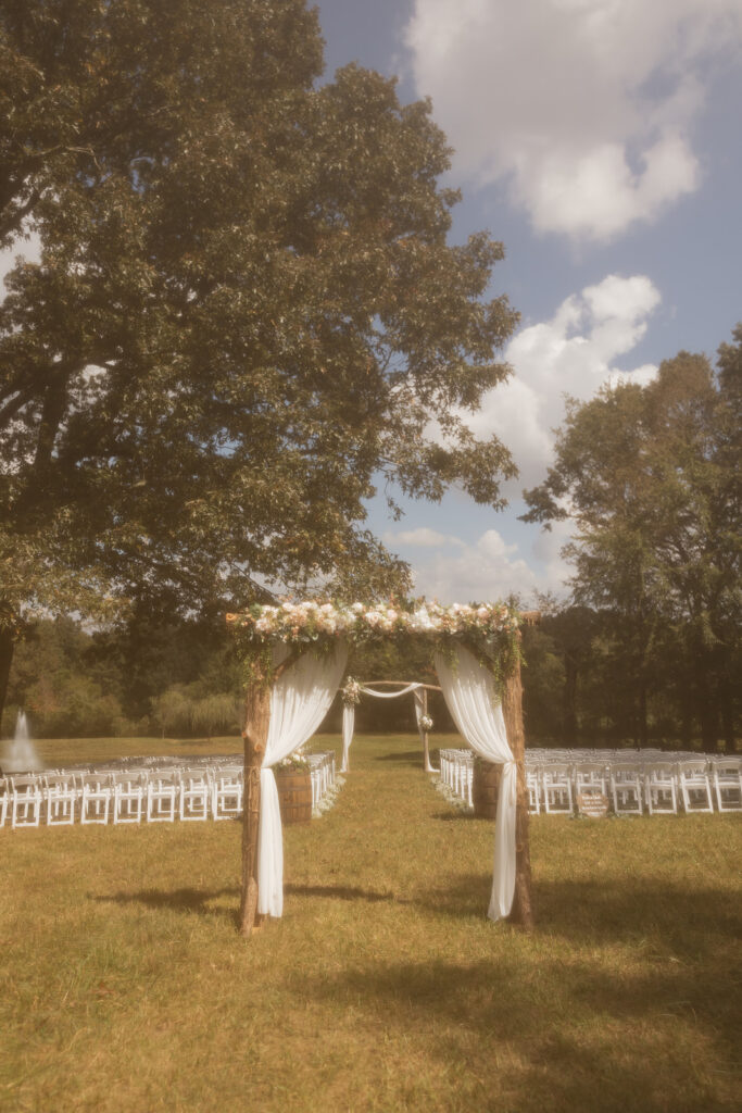 vintage looking photo of the ceremony set up with the arches to walk through and 