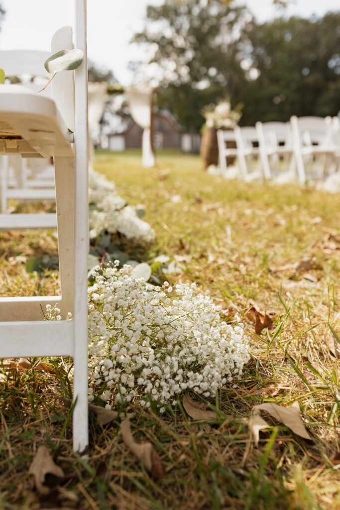 low shot of wedding ceremony chair and floral set up on the ground