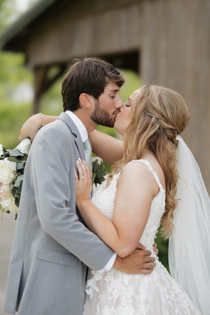 bride and groom kissing before their wedding ceremony