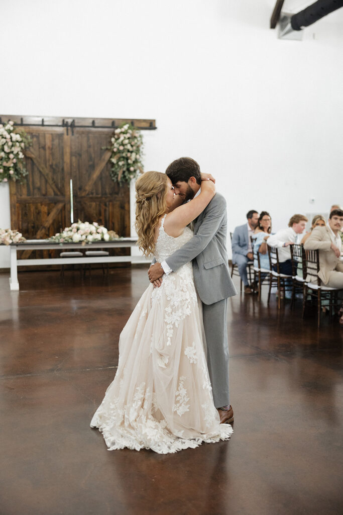 bride and groom hugging after their first dance