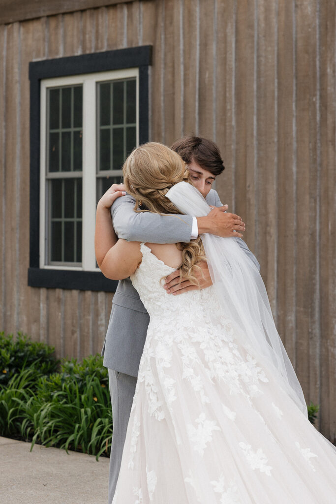 bride and groom hugging after their first look