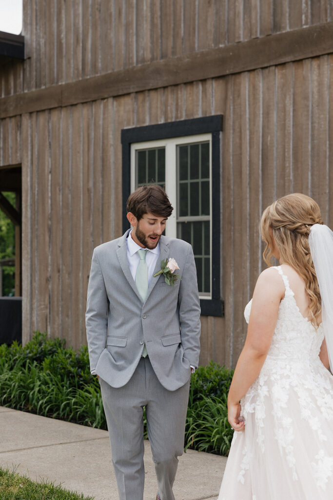 groom emotional seeing the bride in her wedding dress