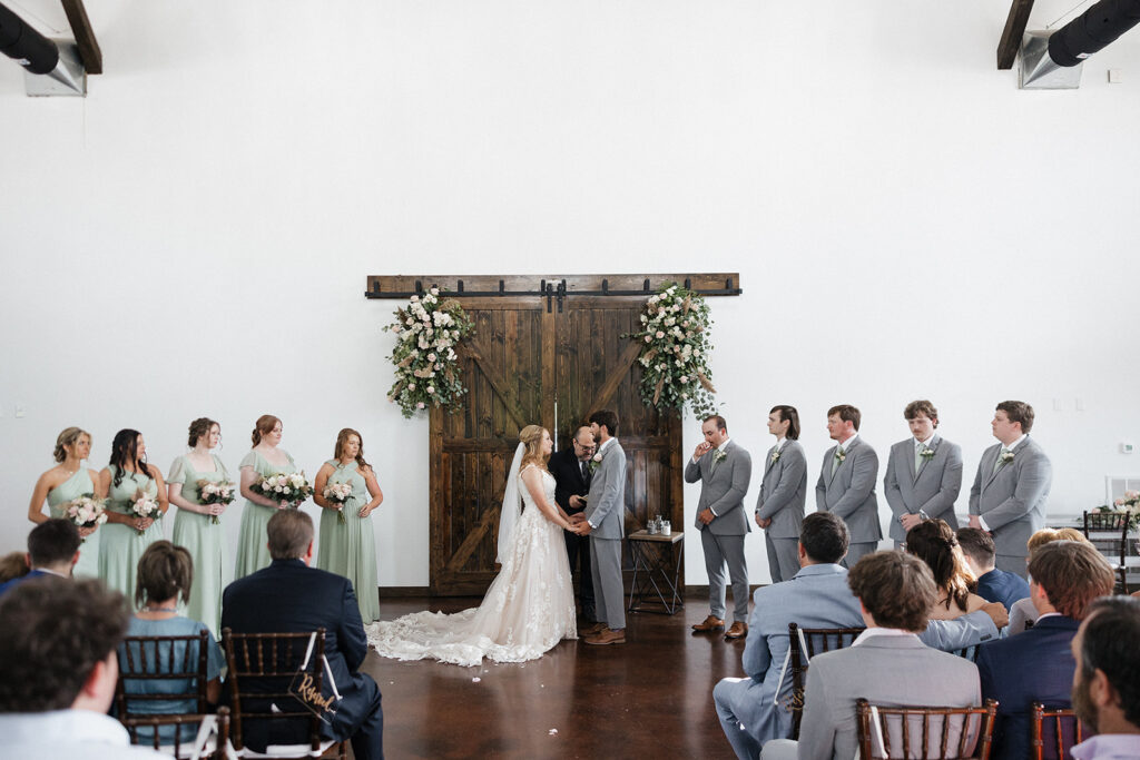 bride and groom holding hands at their stunning wedding ceremony