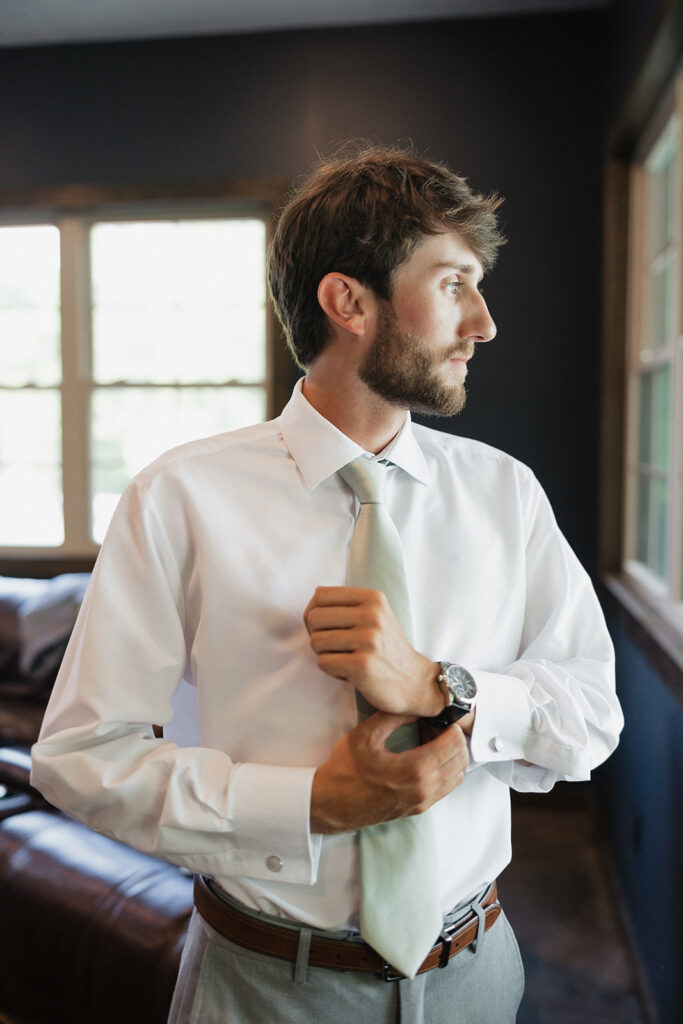 groom getting ready for his elegant wedding ceremony 