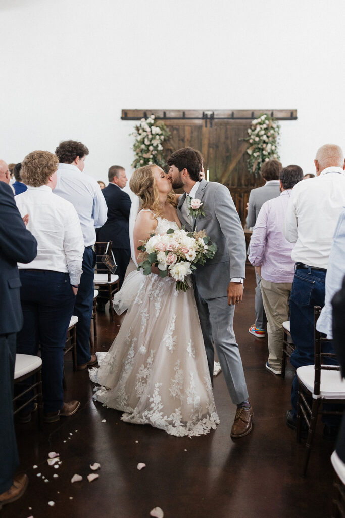 bride and groom kissing after their ceremony