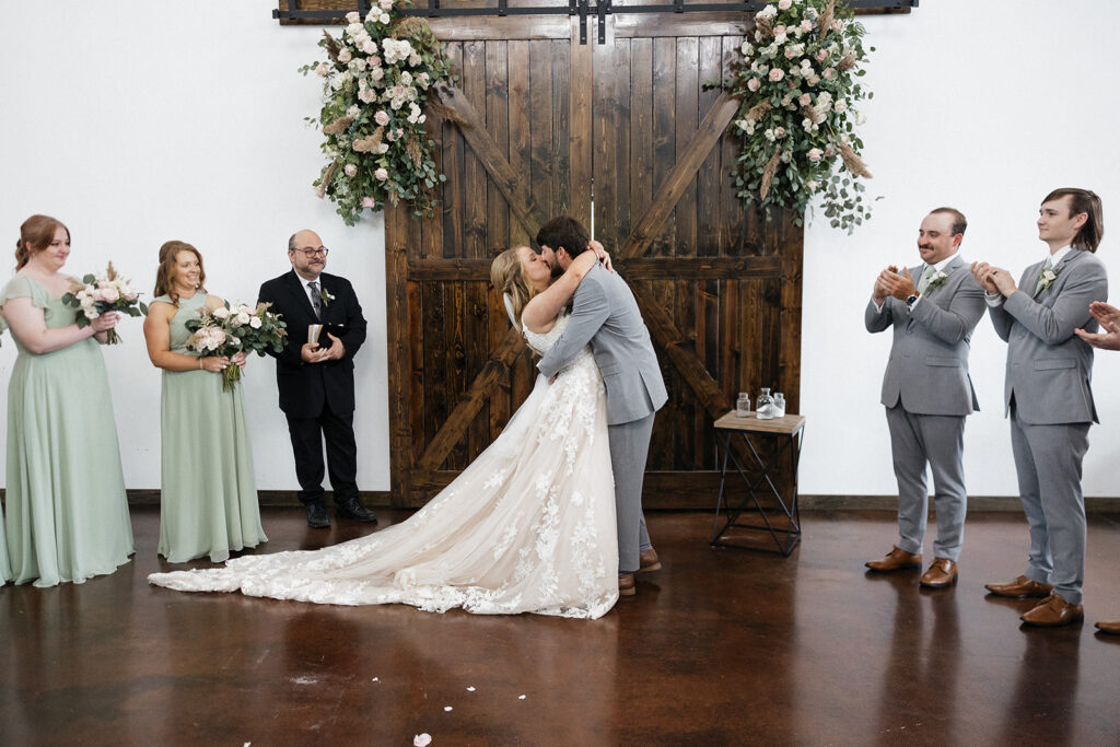 bride and groom kissing after their wedding ceremony