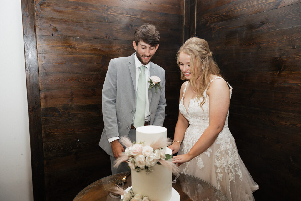 bride and groom cutting their wedding cake