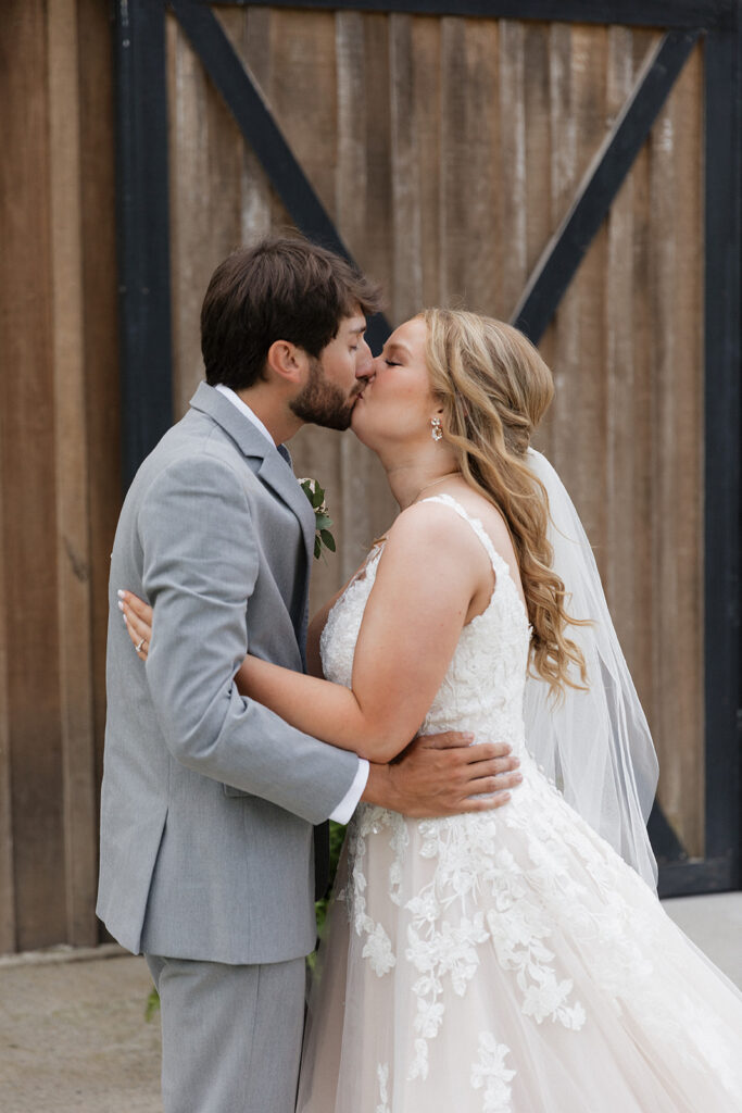 bride and groom kissing after their first look