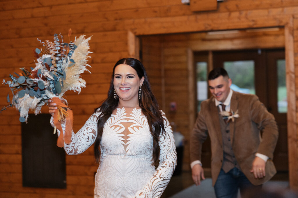 bride and groom entering their boho wedding reception