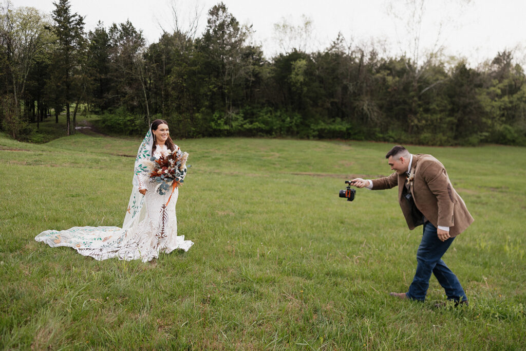 groom taking a picture of the bride 