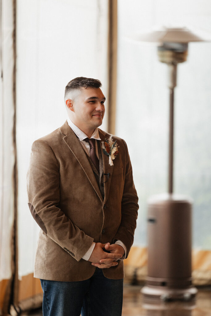 groom watching the bride walk down the aisle 