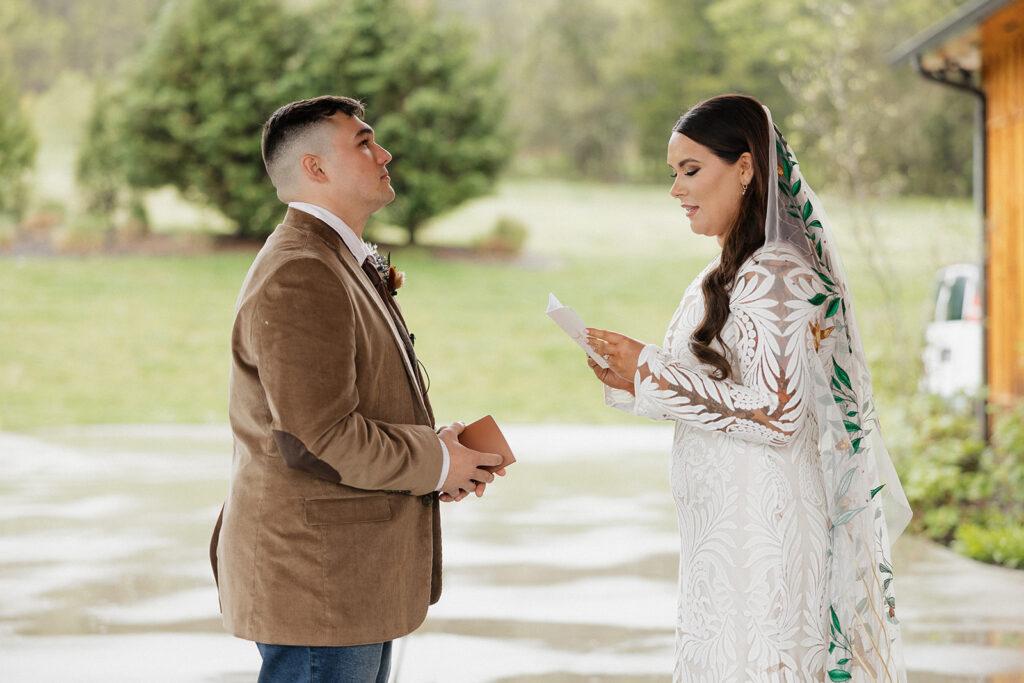 bride and groom reading their wedding vows 