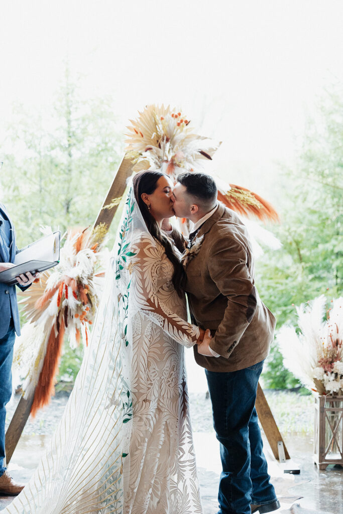 bride and groom kissing after their wedding ceremony 