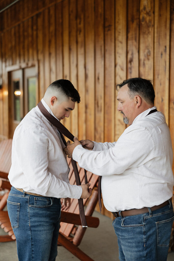 groom getting ready for his boho wedding day 