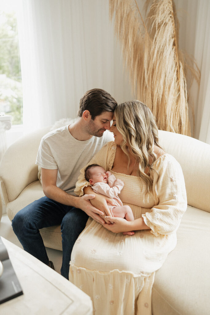 couple at their photoshoot with their baby