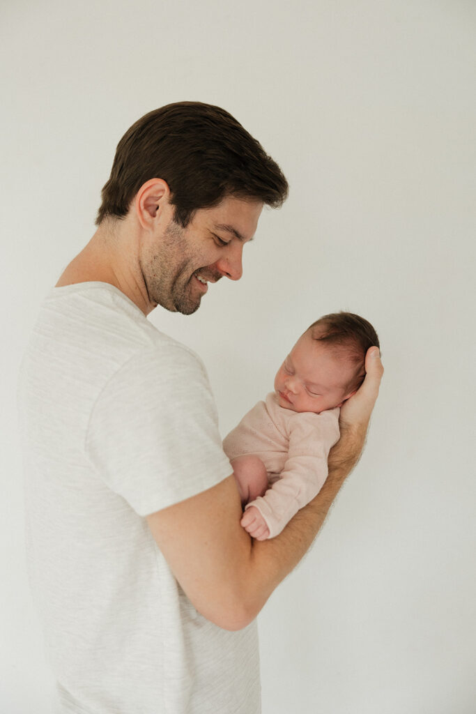 picture of the dad looking at his newborn baby