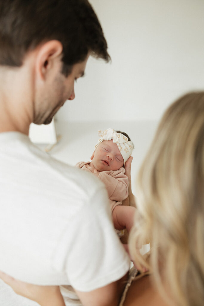 cute parents looking at their newborn baby girl