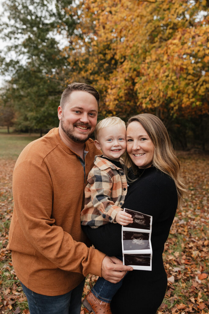 cute family looking at the camera during their photoshoot