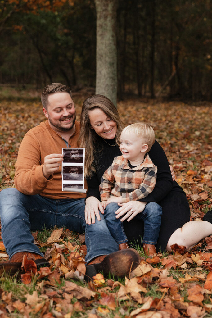 cute family with their new baby sonogram - fall pregnancy announcement 