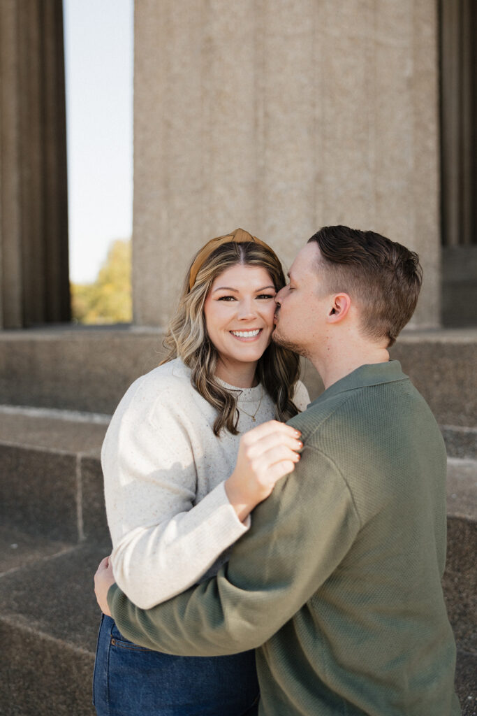 fiance kissing his fiance on the cheek