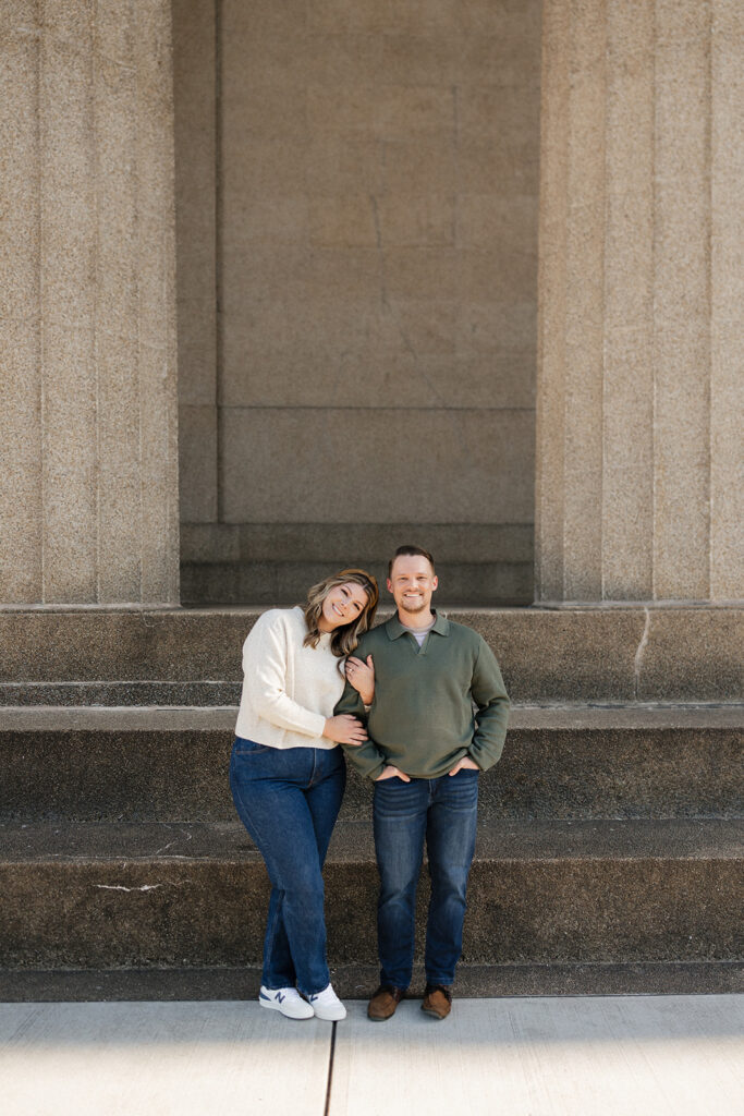 cute couple looking at the camera during their romantic engagement photoshoot