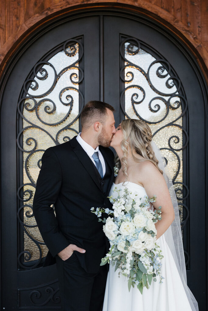 bride and groom kissing before heading to their reception