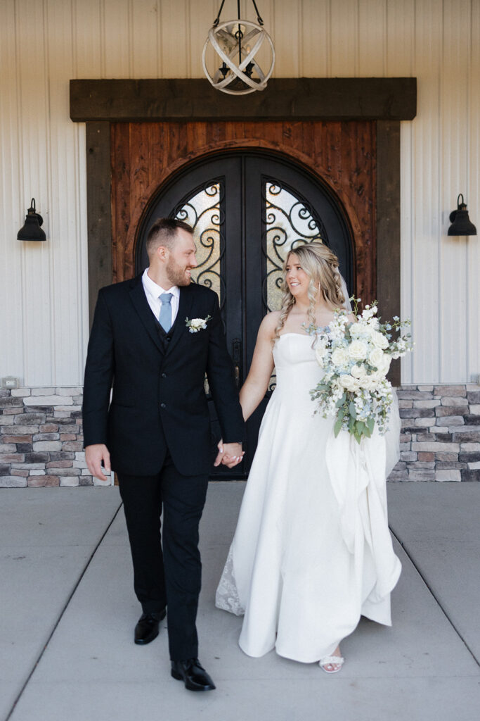 bride and groom smiling to each other