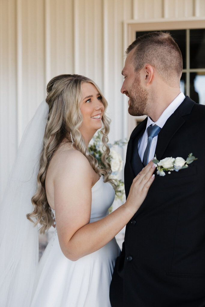 cute couple smiling at each other during their bridal portraits