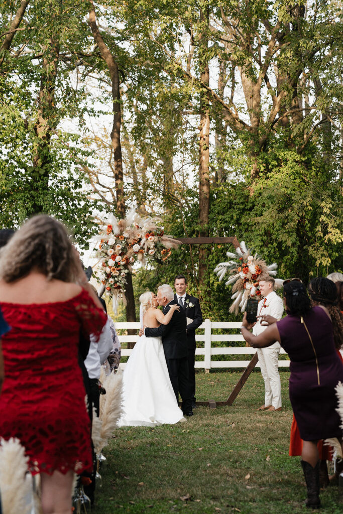 picture of the bride and her dad hugging at the altar 