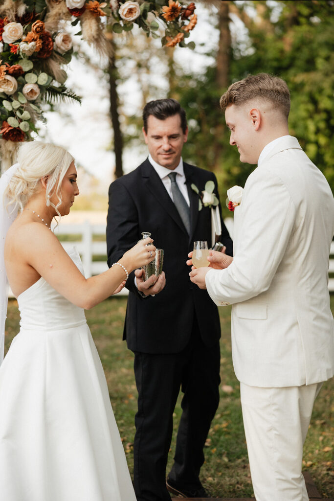 bride and groom taking a margarita shot at the beginning of their ceremony 