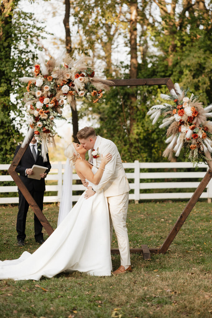 newlyweds kissing after their wedding ceremony