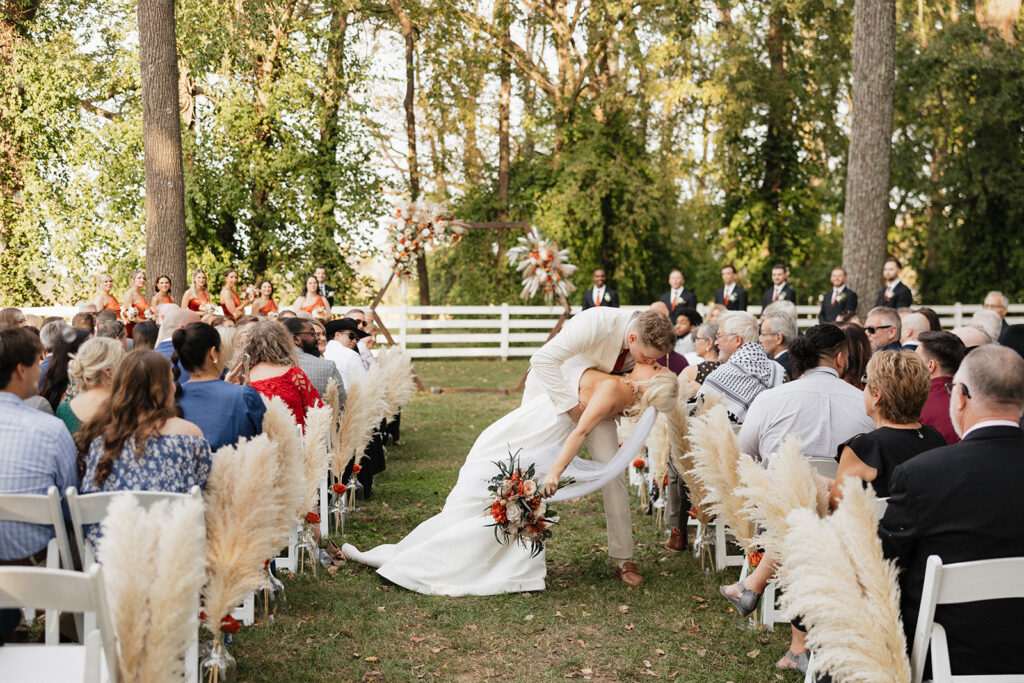 cute picture of the newlyweds kissing after their ceremony