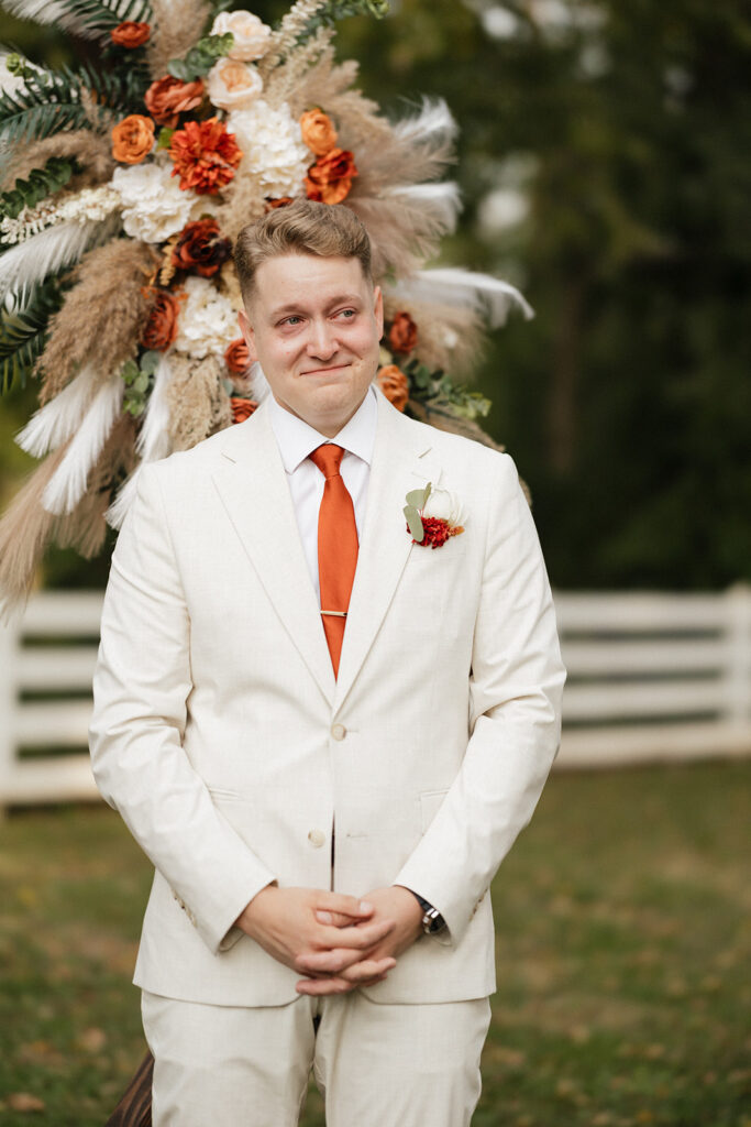 groom emotional watching the bride walk down the aisle