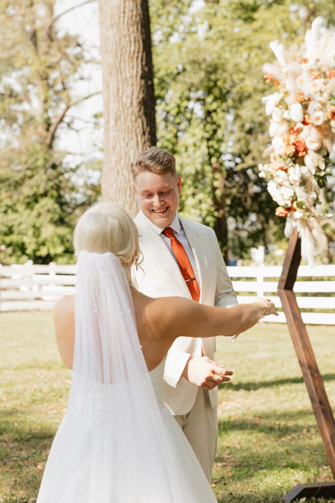 groom emotional seeing the bride in her wedding dress