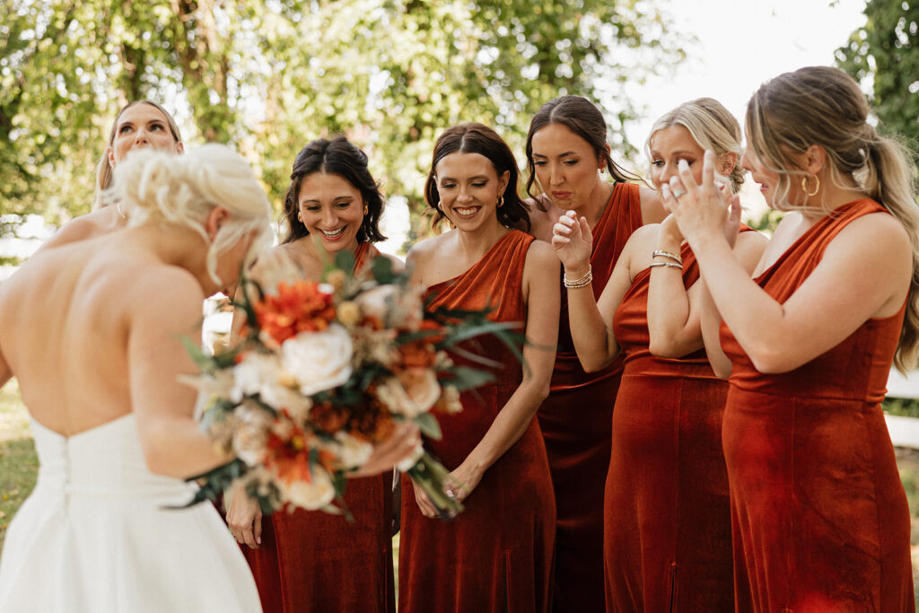 bridesmaids emotional after seeing the bride in her wedding dress