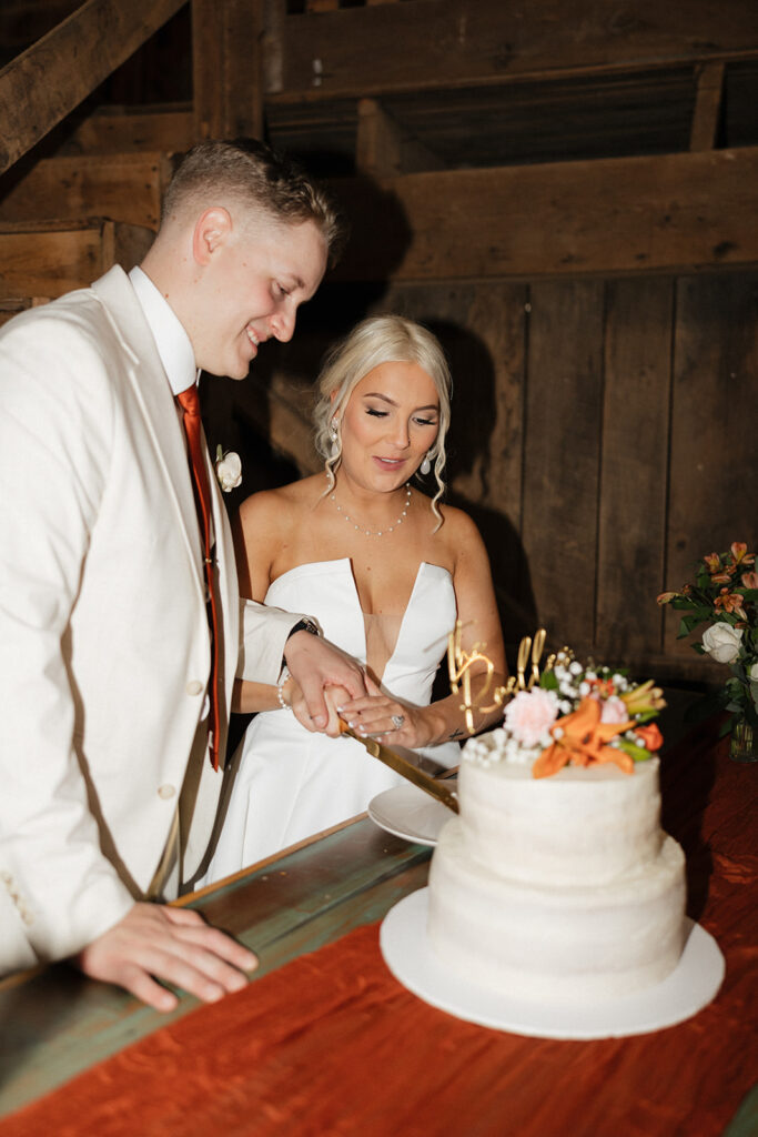 bride and groom cutting their wedding cake 