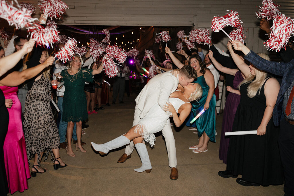 newly married couple kissing after their reception party