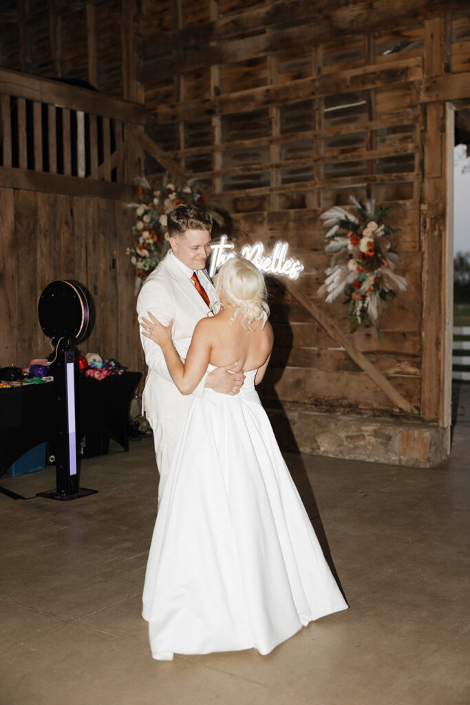 newlyweds during their first dance at their colorful boho wedding reception