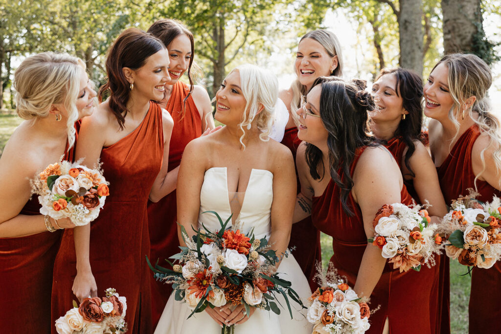 portrait of the bride and her bridesmaids looking at each other