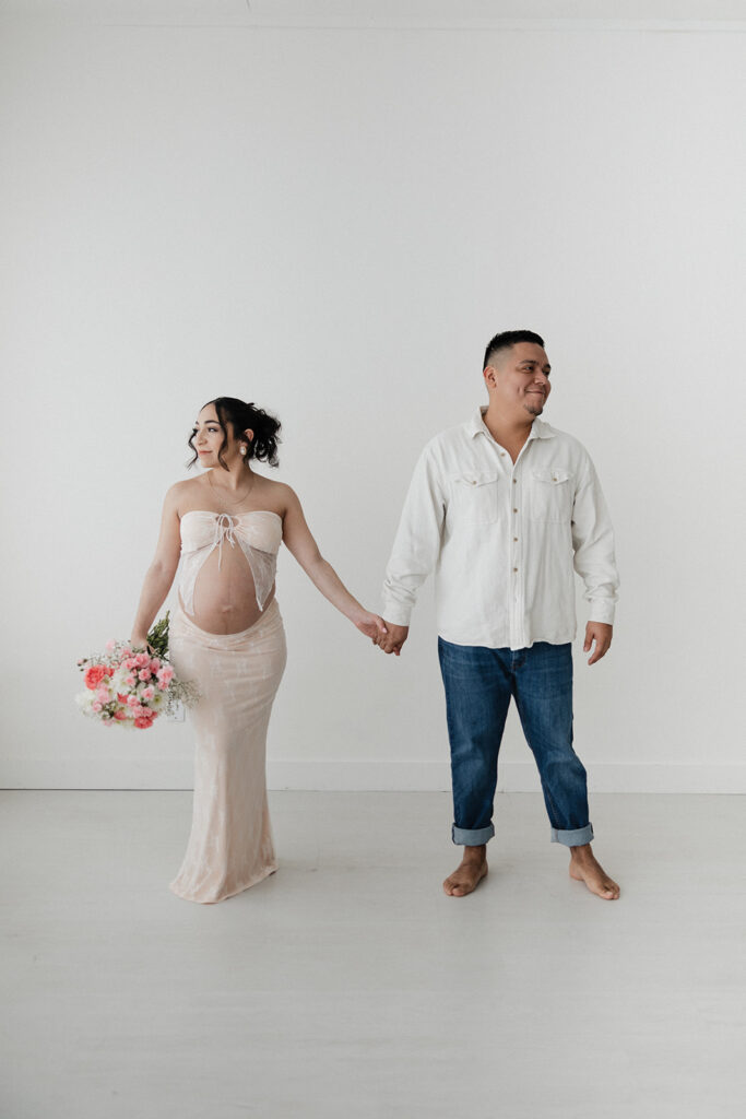 cute couple holding hands during their maternity session