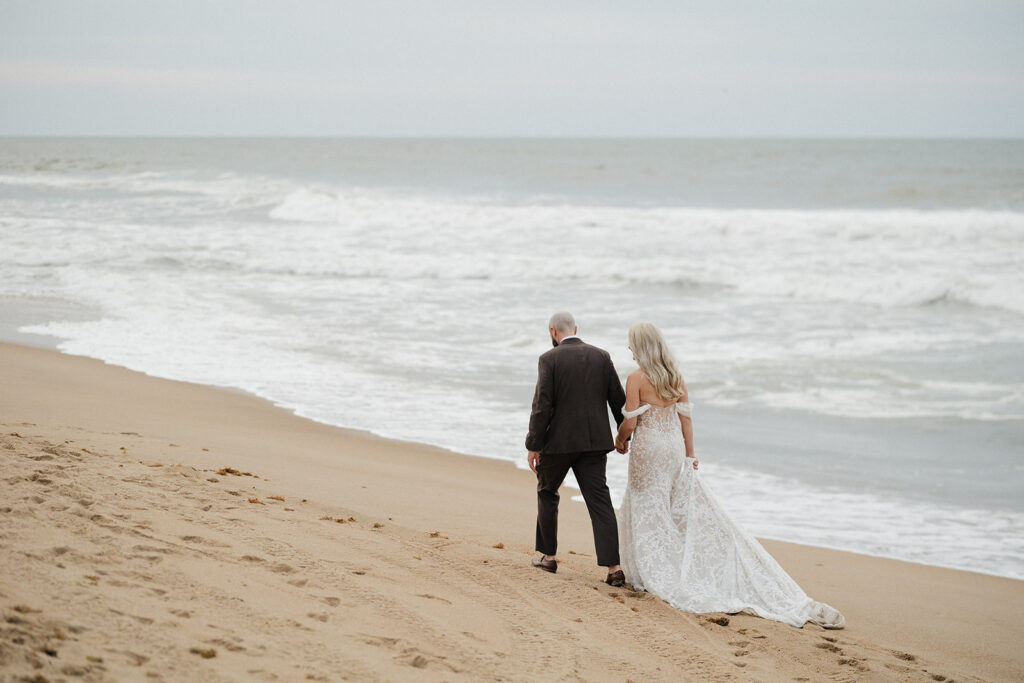 cute couple walking around the beach during their bridal portraits