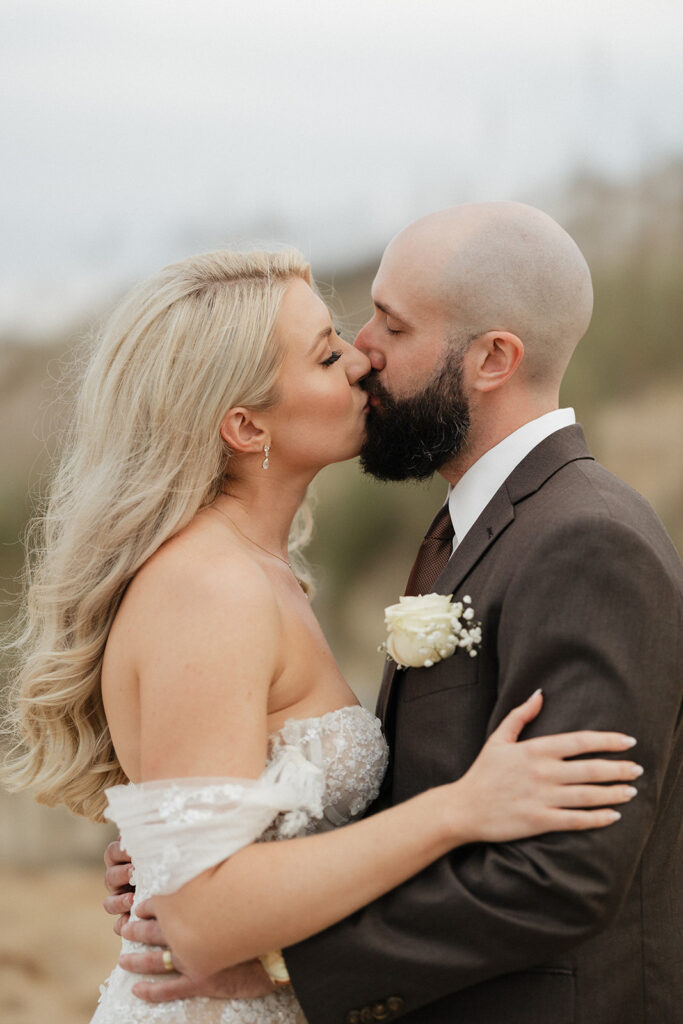 bride and groom kissing during their bridal portraits