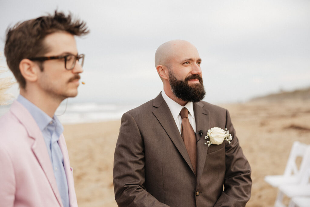 groom watching the bride walk down the aisle