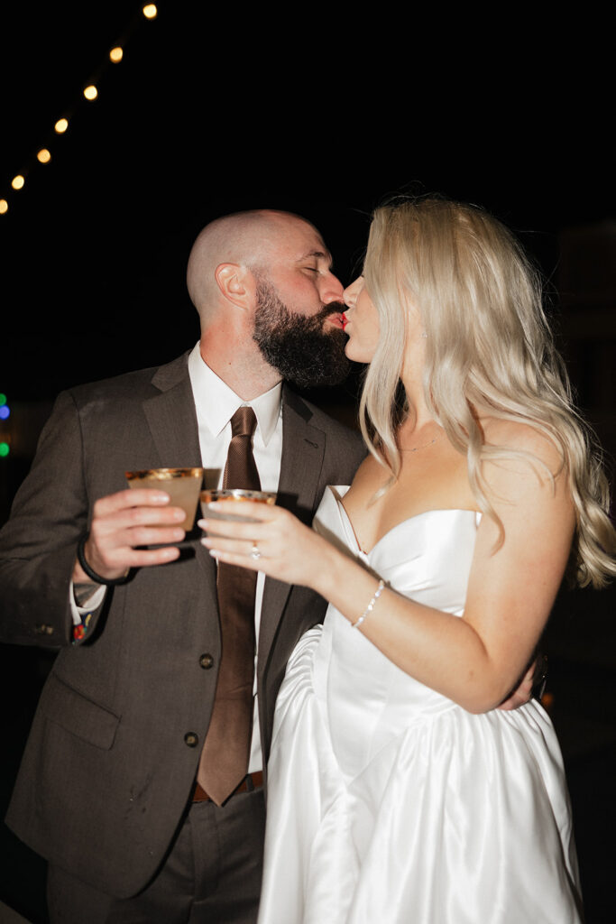 picture of the newlyweds kissing at their reception party