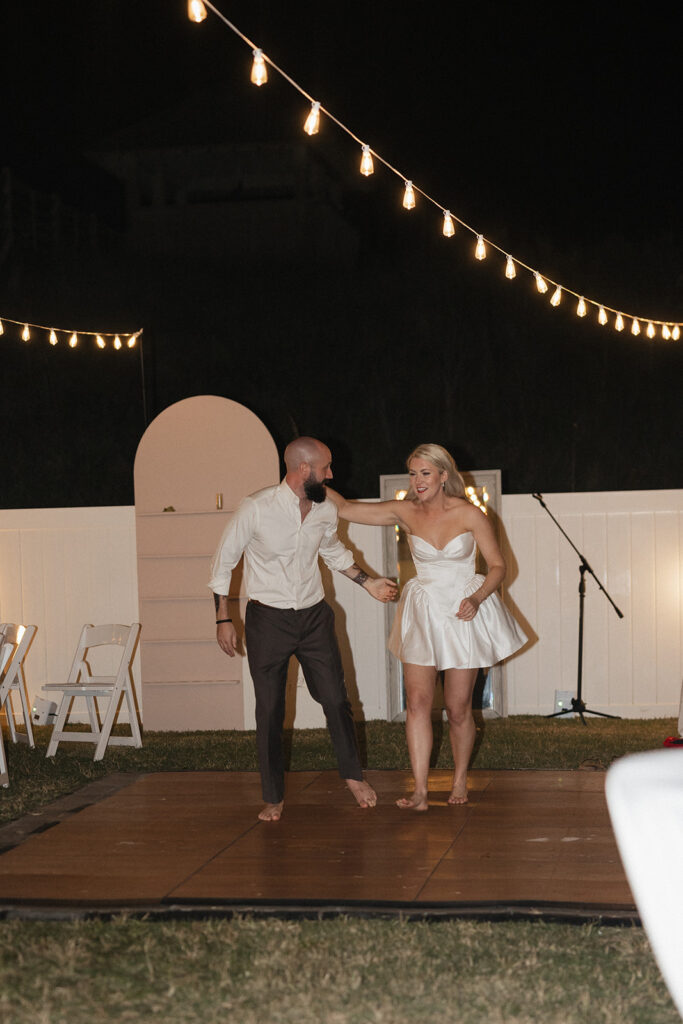 bride and groom jumping in the pool