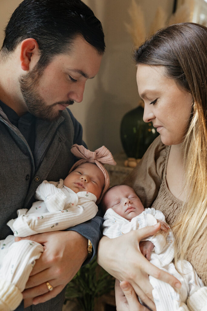 cute couple looking at their babies during their session