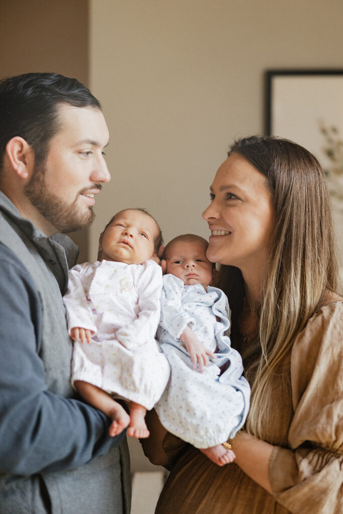 mom an ddad holding their newborn babies