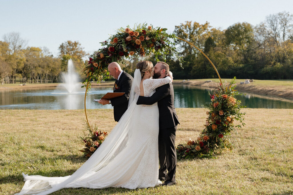 bride and groom kissing after their ceremony