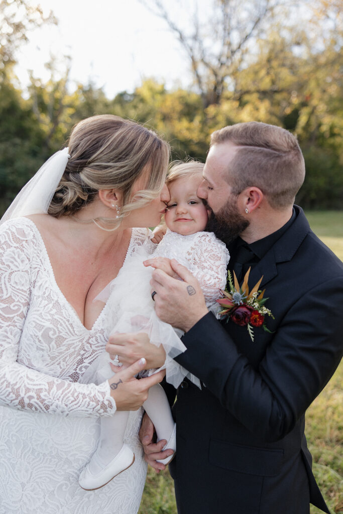 picture of the bride and groom with their daughter