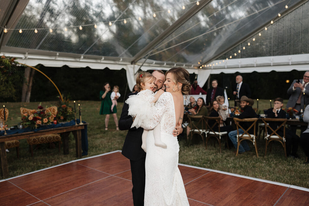 cute couple dancing with their daughter